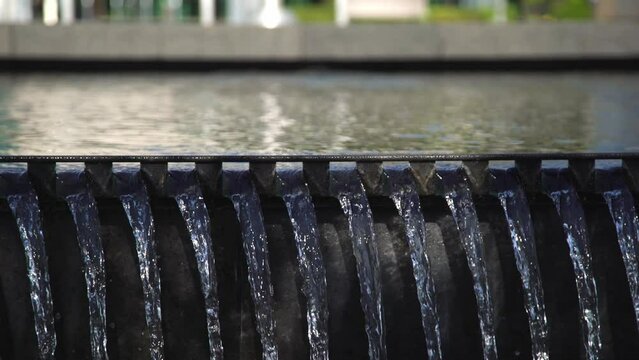 A Waterfall Spilling Over a Wall at Whitby Public Library Square, Framed with a Close Up Panning Shot.