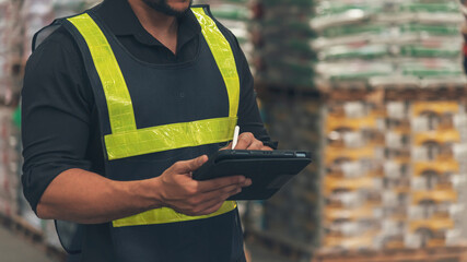 Close up Hispanic men hands using pen touch smart tablet Warehouse management logistics counting checking products on inventory shelf. Man hands worker check stock control in distribution storage