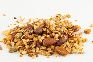 Mix of cashew, almonds nuts, coconut, oat, linseed and toasted pumpkin seed isolated on white background.