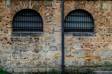 Old prison windows with brick walls