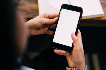 Woman surfing on smartphone in cafe