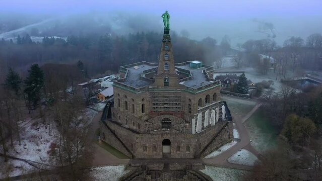 Drone photo, drone shot, drone flight, monumental building Herkules, statue, winter, snowy forest, fog, clouds, detail, Bergpark Bad Wilhelmshoehe, view of the waterworks and the city of Kassel