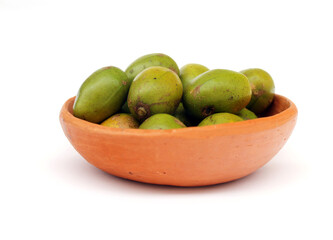 Tropical fruit from Brazil: Caja. Citrus fruit from Latin America in a handmade bowl made of clay.