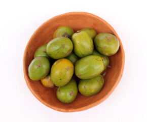 Tropical fruit from Brazil: Caja. Citrus fruit from Latin America in a handmade bowl made of clay. Top view.
