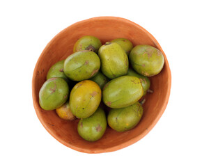 Tropical fruit from Brazil: Caja. Citrus fruit from Latin America in a handmade bowl made of clay. Top view.