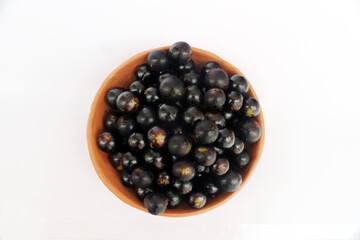 Tropical fruit from Brazil: jabuticaba. Fruit from Latin America in a clay bowl.