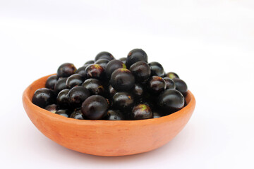 Tropical fruit from Brazil: jabuticaba. Fruit from Latin America in a clay bowl.