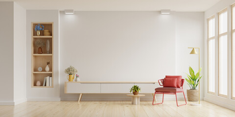 Mockup a TV wall mounted with red armchair in living room with a white wall - 659238174