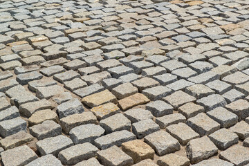 Cobblestones forming a background. Paving stones used in the streets of Brazil.