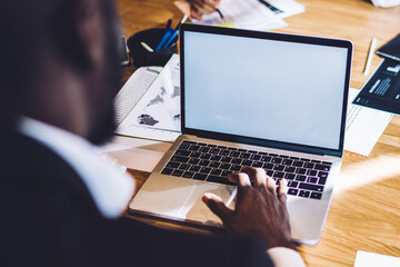 Black man surfing laptop in office
