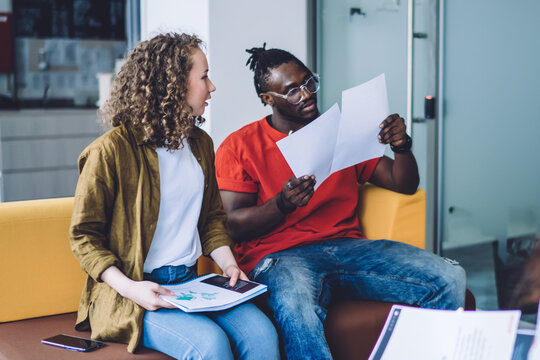 Casual coworkers with papers in office