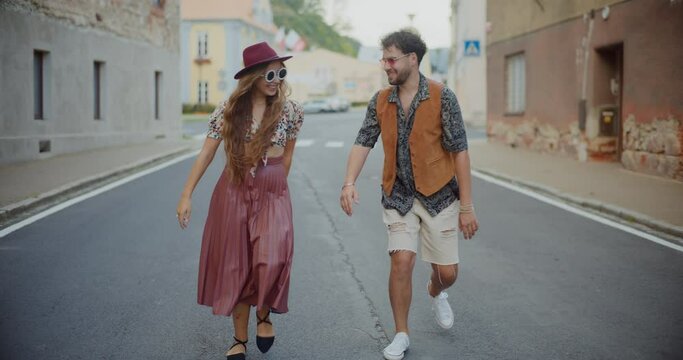 Woman enjoys dancing with boyfriend on road in town
