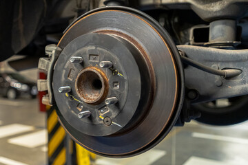 Close up view of a Maintenance Car service - auto oil change, motor check, brake cleaning, tire check, engine inspection, motor oil-brake inspection