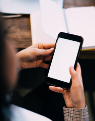 Woman surfing on smartphone in cafe