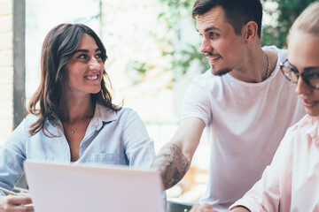 Business partners using gadgets in work and talking to each other