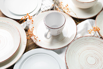 Clean ceramic plates, cup and floral decor, closeup