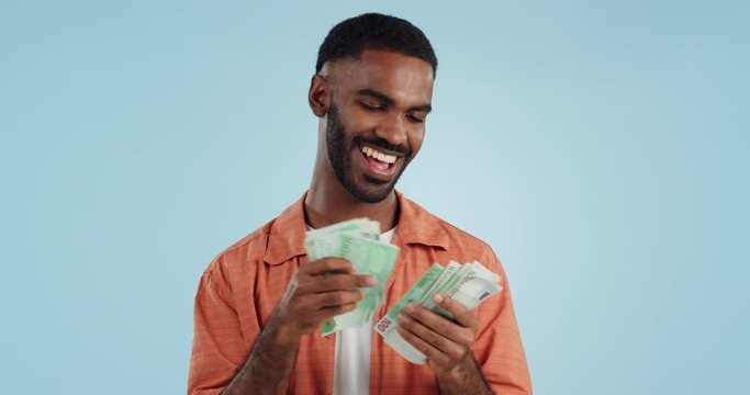 Man, count cash and happy in studio with success, bonus or promotion with winning by blue background. Investor, trader or person with money, salary or savings for financial freedom or profit