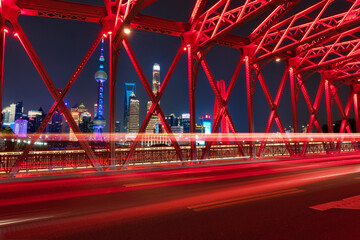 Fototapeta na wymiar a famous bridge of The Bund in Shanghai at night and beautiful light trail at highway