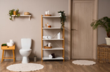 Blurred view of modern restroom with toilet bowl and shelving unit - Powered by Adobe