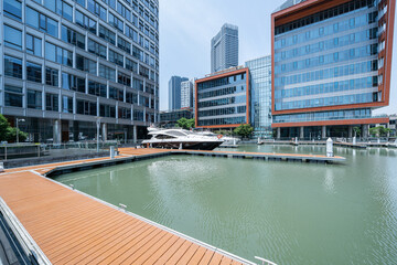 financial district buildings of shanghai  in sunny day and the yacht docked at the dock