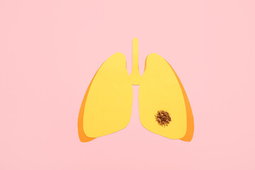 Paper lungs with tobacco on pink background. Lung cancer concept