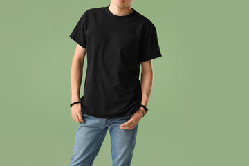 Man in stylish t-shirt on green background