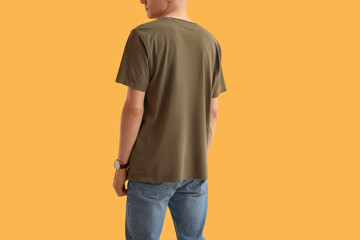 Man in stylish t-shirt on orange background