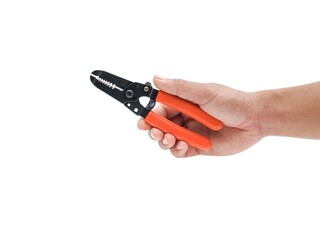 Male hand holding wire stripping pliers with orange handles isolated on white background.