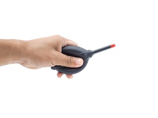 Male hands holding cleaning equipment for camera and computer lens.  Black blower with red tip for blowing dust.  Set isolated on white background.