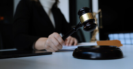 Judge gavel with Justice lawyers having team meeting at law firm in background. Concepts of law.