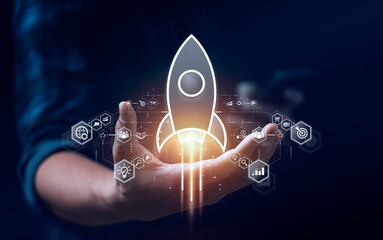Startup business concept, rocket is launching and flying from hand to sky for growing business,...