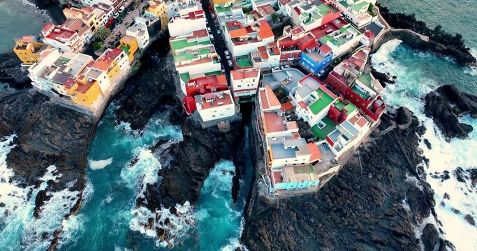 Beautiful aerial view of island Tenerife Spain, Canary Islands. Ocean, sea, city, color houses and waves. Amazing landscape on the sunset to Puerto de la cruz