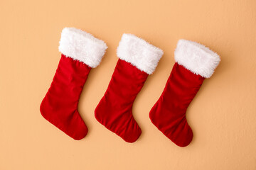 Obraz na płótnie Canvas Christmas socks hanging on orange background