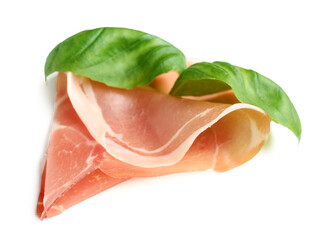 Slice of tasty prosciutto with basil on white background