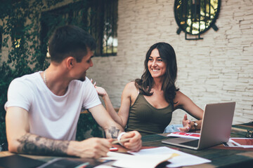 Young happy people studying together in terrace