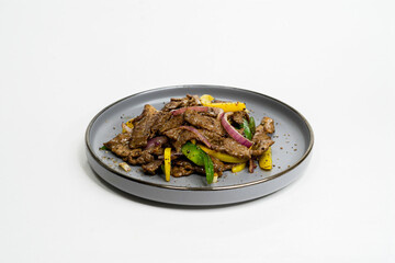 black pepper beef with vegetables on a plate