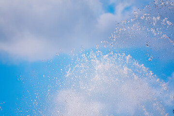 Splashes of water against the blue sky background