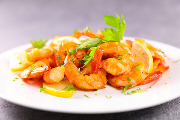 grilled shrimps with herbs and lemon on plate