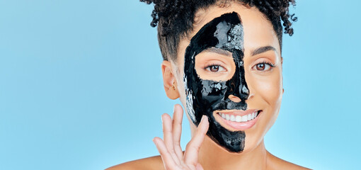 Skincare, charcoal mask and portrait of happy woman for facial treatment, spa and wellness in studio. Beauty, dermatology and face of person for health, cosmetics and grooming on blue background