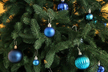 Christmas tree decorated with blue baubles, closeup