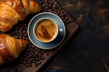 freshly baked croissants and coffee cup on grey table, top view 