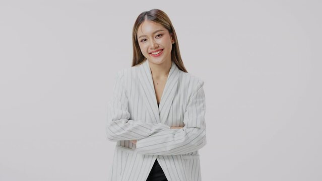 Portrait of woman wearing formal wear blazer white shirt smiling on gray background. Business concept.