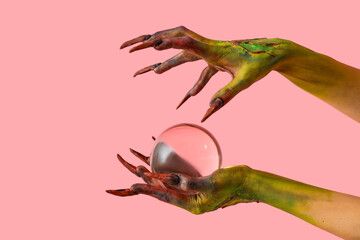 Witch with crystal ball of fortune on pink background. Halloween celebration