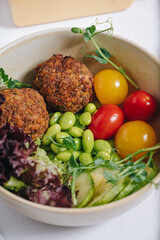 bowl in Chinese style.meatballs with beans, herbs, cherry tomatoes and sauce in a bowl