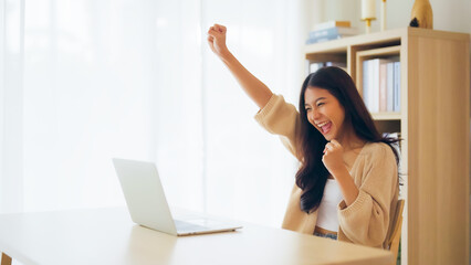 Funny euphoric young asian woman celebrating winning or getting ecommerce shopping offer on...