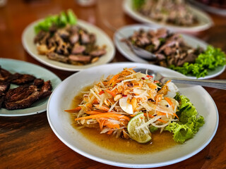 Thai local street food by home cooking chef, Isaan Food, Thai Food Dishes Som tum. Som Tam Thai green papaya salad taste buds with its sweet, spicy, salty and sour elements