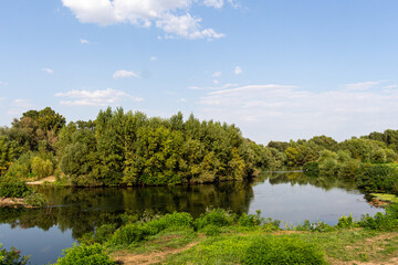 Fototapeta premium Landscape with river, trees and blue sky