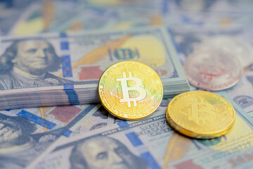 Golden mockup coin Bitcoin infant of mock up one hundred dollars banknotes. Exchange bitcoin cash for a dollars. Cryptocurrency on US dollar bills. Digital modern method of payment.