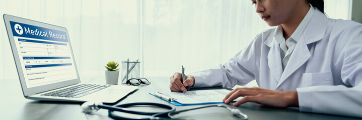 Doctor carefully review detailed medical report on laptop and diagnosing illness for effective...
