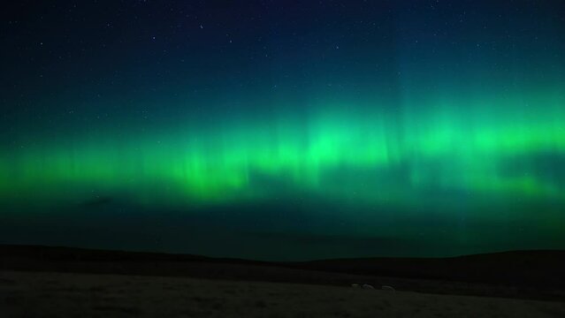 Dynamic timelapse of the aurora borealis over fields of sheep in Scotland.